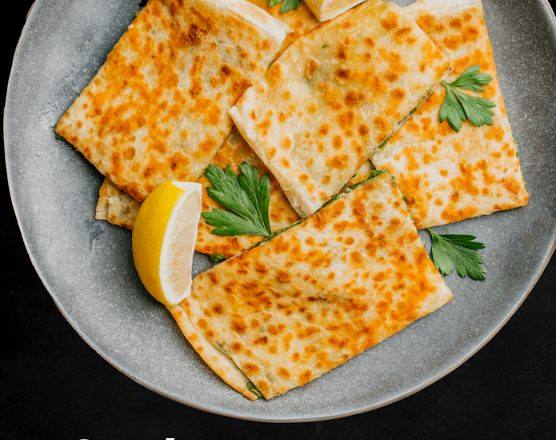 Gozleme with lemon wedges